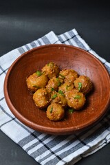 Cilok is balls prepared with a base of tapioca flour. Whether boiled or fried, cilok balls are typically accompanied by a sweet peanut sauce or spicy sauces based on ketchup and kecap manis. 
