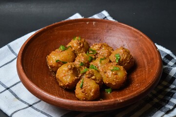 Cilok is balls prepared with a base of tapioca flour. Whether boiled or fried, cilok balls are typically accompanied by a sweet peanut sauce or spicy sauces based on ketchup and kecap manis. 