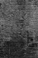 Background with brick wall grown with mos and ancient medieval window shape