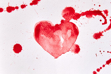 Drawing of a red heart shape with blots in watercolor on white paper.