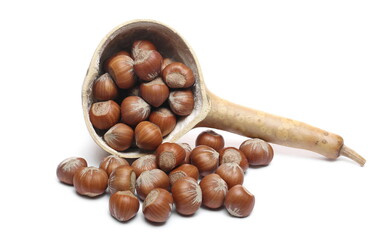 Hazelnuts pile with calabash, gourd half isolated on white background
