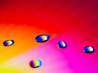 Close-up of water drops on a coloured surface