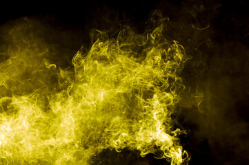 Yellow smoke isolated on black background. Abstraction