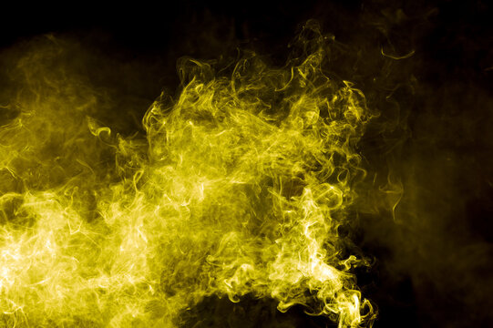 Yellow smoke isolated on black background. Abstraction