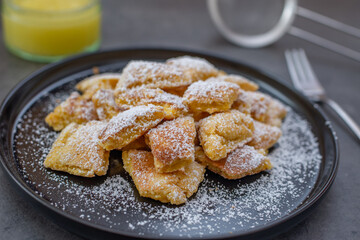 Austrian cuisine. Torn pancake (or omelet) kaiserschmarrn with honey, powdered sugar