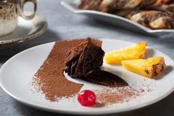 Chocolate cake with fruits.Chocolate truffle. Plate art composition.
