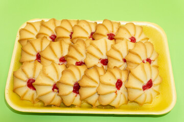 A plate of short bread cookies with pecans .