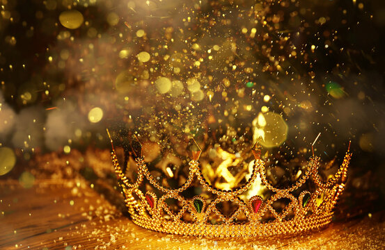 Fantasy world. Beautiful golden crown on table, bokeh effect