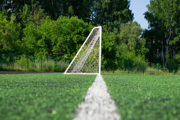 Goal with net stand on a soccer or football field.
