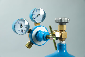 Pressure gauge of medical oxygen tank on light grey background, closeup