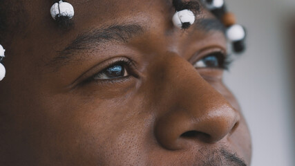 Close up, peaceful look in the eyes of african american black man looking at the sky. High quality photo