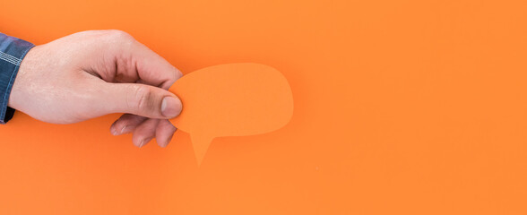 Male hand holding Speech balloon shape card.