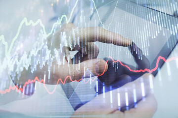 Multi exposure of man's hands holding and using a phone and financial chart drawing. Market analysis concept.