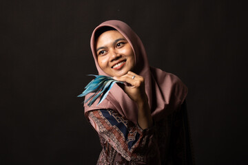 Happy young woman with cash money on black background