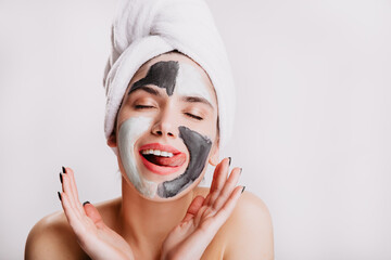 Contented lady licks her lips during sleep procedures for face. Model makes morning routine on...