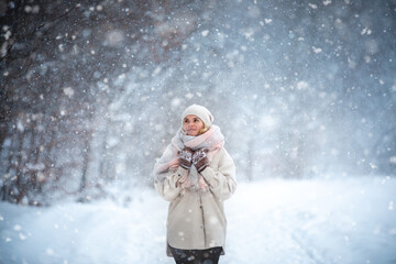 Fototapeta na wymiar Beautiful woman in wintertime among snow