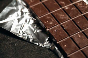 Handmade raw vegan chocolate on black background