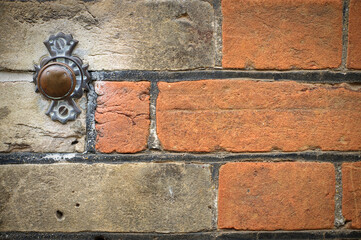 Door bell button on brick wall