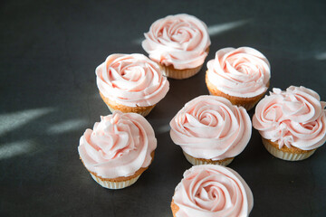 Cupcakes with butter cream on dark background
