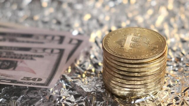 A stack of bitcoin and a wad of dollars. The concept of cryptocurrency exchange