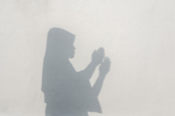 Muslim Woman natural shadow praying overlay effect on white wall  texture background.