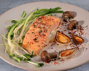 colorful food art composition on plate with piece of salmon. Top view.