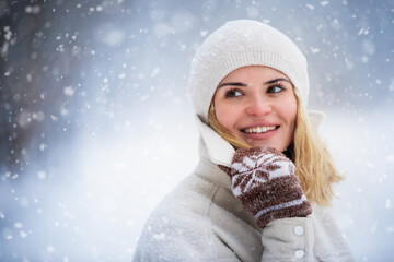 Smiling woman enjoying winter among snow outdoor