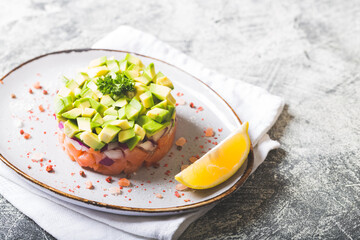 Raw salmon, avocado and purple onion salad. salmon tartar