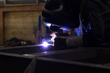 Metal workers use manual labor, Skilled welder, Factory workers making OT. Welder is welding the steel in the factory.