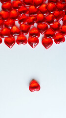 Festive background: lots of red hearts on a white background. Space for the text. Small stones in...