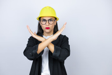 Young architect woman wearing hardhat Pointing to the eye watching you gesture, suspicious expression