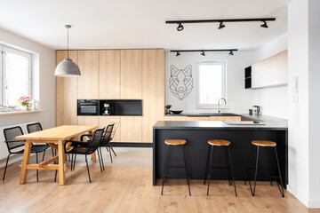 Modern interior of kitchen with kitchen island, granite kitchen island, wooden furnitureand stylish...