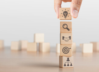 Business strategy, business management or business success concept. Hand arranging wooden blocks...