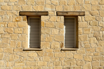 Fototapeta na wymiar Stone wall with two windows