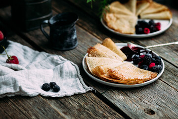 Thin Pancakes with jam and berries. Breakfast. Maslenitsa holiday