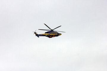 Fototapeta na wymiar A helicopter flying in the sky.