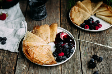 Thin Pancakes with jam and berries. Breakfast. Maslenitsa holiday