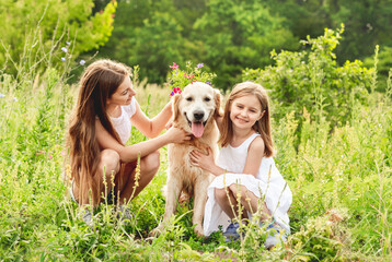 Pretty girls playing with cute dog