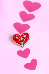 Red heart made of beads. Pink hearts. The concept of the Valentine's Day theme. A greeting card, a declaration of love.