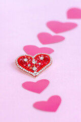 Red heart made of beads. Pink hearts. The concept of the Valentine's Day theme. A greeting card, a declaration of love.
