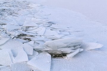 Fototapeta na wymiar Pieces of blue ice on a frozen lake. Eastern Europe. Landscape. Horizontal orientation.
