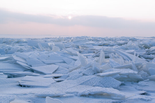 Cracked and re-frozen white ice on the reservoir. Eastern Europe. Landscape. Horizontal orientation.