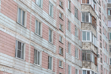 The facade of a residential building requiring cosmetic repairs