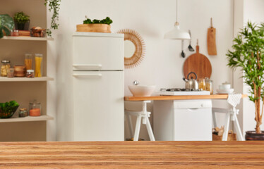 Close up wooden table and decorative kitchen background style. Refrigerator, dishwasher and stove style with lamp concept.