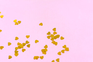 Pink background with gold hearts, sequins. The concept of the Valentine's Day theme. Postcard, template, background