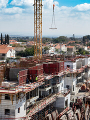 Construction crane on the construction site of a high-rise building