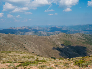 Mountain landscape in Gennargentu, highest mountain in Sardinia, Nuoro, Italy. Vaste peaks, dry plains and valleys with mediterranean vegetation. Late summer, blue sky