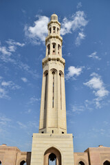 Fototapeta na wymiar A minaret in Sultan Qaboos Grand Mosque in contrast with the blue sky. Muscat, Oman.