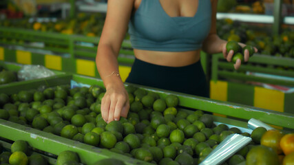 European girl chooses organic fruits in the store