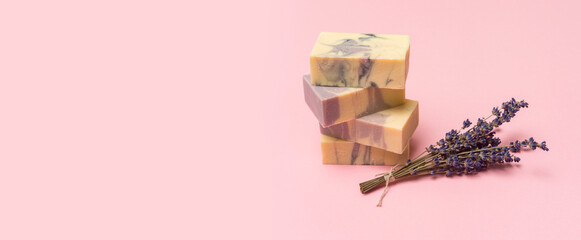Natural handmade soap with dried lavender and essential oil on pink background. Zero waste concept